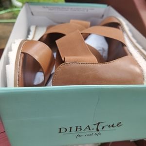 Leather and elastic straps wrap a casual sandal wi